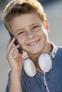 Portrait of boy talking on phone outdoors. Royalty Free Stock Photo