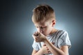 Portrait of a boy using an asthma inhaler to treat inflammatory diseases, shortness of breath. The concept of treatment for cough Royalty Free Stock Photo