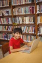 Portrait of boy using laptop in library Royalty Free Stock Photo