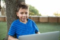 Portrait of boy using laptop at park Royalty Free Stock Photo