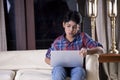 Portrait of a boy using laptop while sitting on sofa at home Royalty Free Stock Photo