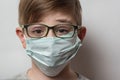 Portrait of boy wearing glasses and medical mask. Child wears protective face masks