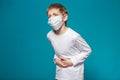 Portrait of a boy wearing protection mask having stomach ache Royalty Free Stock Photo