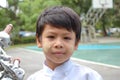 Portrait of a boy wearing white clothes, basketball court.