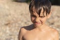 Portrait of a boy who recently came out of the water. Hair and skin are wet. Water drips from the face Royalty Free Stock Photo