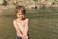 Portrait of a boy who recently came out of the water. Hair and skin are wet. Water drips from the face Royalty Free Stock Photo