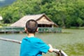 Portrait of a boy and The wooden raft in the water reservoirs. Royalty Free Stock Photo