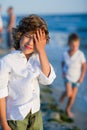 Portrait of boy of 10-11 years against the background of the rough sea.