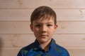 Portrait of a boy 8 years old brunette in a blue shirt. A very serious look. Royalty Free Stock Photo