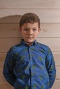 Portrait of a boy 8 years old brunette in a blue shirt. A very serious look. Royalty Free Stock Photo