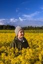 Portrait of a boy on a yellow field of flowers Royalty Free Stock Photo