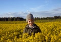 Portrait of a boy on a yellow field of flowers Royalty Free Stock Photo