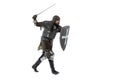 Portrait of brave medieval warrior, knight in special coat of mail attaching with sword isolated over white studio