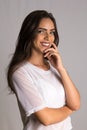 Portrait of Brazilian young female brunette model with arms crossed and smiling with confidence