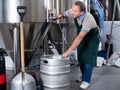 Portrait of brewer who is making beer and controls the process in the brew-house.