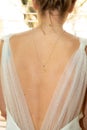 Portrait of bride back necklace behind on wedding dress