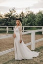 Portrait of the bride. A beautiful woman in white wedding dress in bohemian style. Sunset Royalty Free Stock Photo