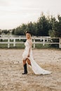 Portrait of the bride. A beautiful woman in white wedding dress in bohemian style. Sunset Royalty Free Stock Photo