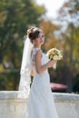 Portrait of bride with bouquet in park Royalty Free Stock Photo