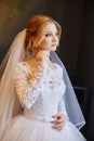 Portrait of a bride in a chic white wedding dress preparing for Royalty Free Stock Photo