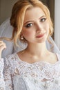 Portrait of a bride in a chic white wedding dress preparing for Royalty Free Stock Photo