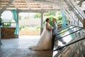 Portrait of the bride and groom on wedding day. The groom in a gray business suit holds the bride in a white luxury Royalty Free Stock Photo