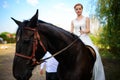 Portrait of a bride on horseback on the background of a summer s