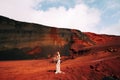 Portrait of a bride model in a golden wedding evening dress, in a yellow-red sandy quarry, in the crater of a volcano in