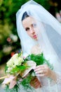 Portrait of a bride in veil and with a bouquet of flowers Royalty Free Stock Photo