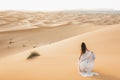 Portrait of bride woman in amazing wedding dress in Sahara desert dunes, Morocco Royalty Free Stock Photo