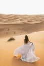 Portrait of bride woman in amazing wedding dress in Sahara desert dunes, Morocco Royalty Free Stock Photo