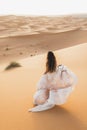 Portrait of bride woman in amazing wedding dress in Sahara desert dunes, Morocco Royalty Free Stock Photo