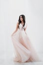 Portrait of bride. A young attractive brunette woman with long black hair in braids. White wedding dress and beige hat Royalty Free Stock Photo