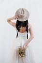 Portrait of the bride. A young attractive brunette woman with long black hair in braids. White wedding dress and beige Royalty Free Stock Photo