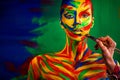 Color art face and body painting on woman for inspiration. Abstract portrait of the bright beautiful girl with colorful