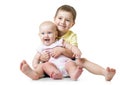 Portrait of brother hugging his little cute sister sitting on floor isolated on white background
