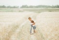 Portrait of brother and little sister together on summer wheat field Royalty Free Stock Photo