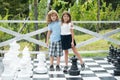 Portrait of brother and sister hug on big chess board in summer park outdoors. Little boy and girl kids enjoying summer Royalty Free Stock Photo