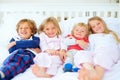 Portrait, brothers and sisters together on bed with relax wellness, happiness and sibling support in home. Boys, girls Royalty Free Stock Photo