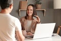 Portrait of brown haired Caucasian businesswoman showing her credit card at bank, brown haired female on financial meeting telling Royalty Free Stock Photo