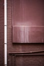 Portrait Brown painted grungy brick wall with pipes and dripping