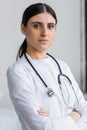 Portrait of brunette doctor crossing arms Royalty Free Stock Photo