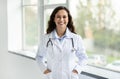Portrait of brunette european young woman doctor with stethoscope Royalty Free Stock Photo