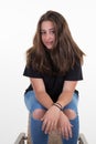 Portrait brunette girl long hairs sit on chair beautiful young woman on white background Royalty Free Stock Photo