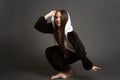 Portrait of a brunette girl in the Studio on a plain black background in black and white pajamas with a hood Royalty Free Stock Photo