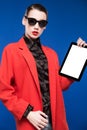 Portrait of a brunette in a jacket with a tablet in hand Royalty Free Stock Photo