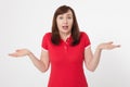 Portrait of brunette surprised happy woman in blank red t-shirt with copy space on white background. Mock up. Menopause