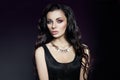 Portrait of a brunette woman with a chic hairstyle and a necklace around her neck, jewelry. Natural cosmetics and beautiful bright