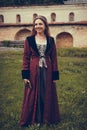Portrait of brunette woman dressed in historical Baroque clothes with old fashion hairstyle, outdoors Royalty Free Stock Photo