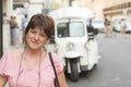 Portrait of brunette woman in front of a mototaxi in Lisbon, Portugal, Europe Royalty Free Stock Photo